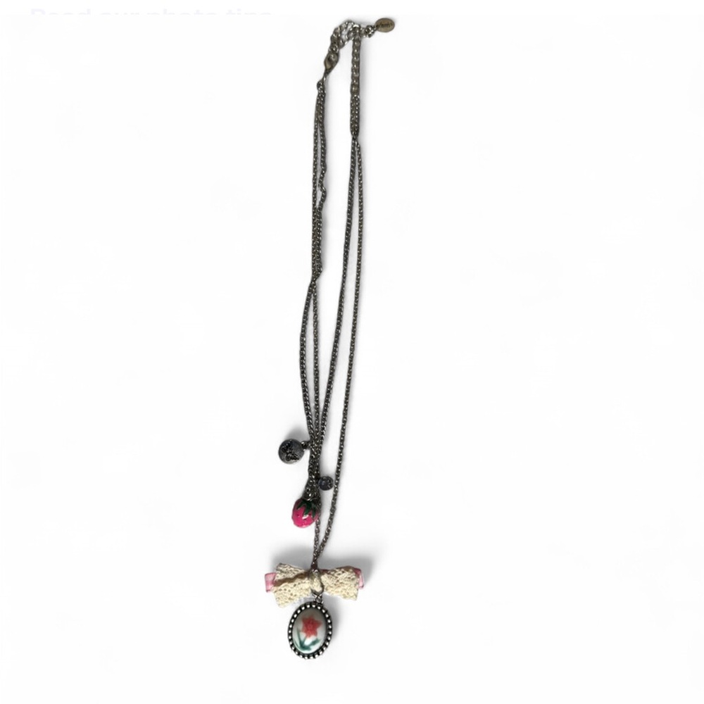 Elegant Bow Pendant Necklace with Red and Silver Accents Claire’s